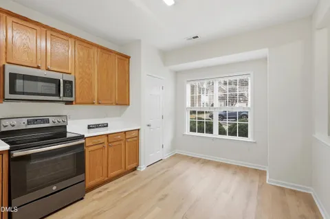 a kitchen with stainless steel appliances granite countertop a stove microwave and sink