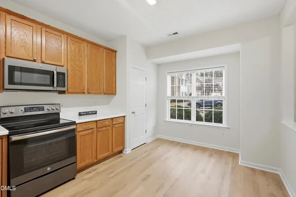 a kitchen with stainless steel appliances granite countertop a stove microwave and sink