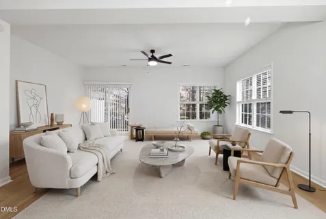 a living room with furniture a window and a table
