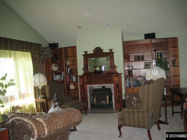 4320 Warren Way Reno, NV 89509 - Photo 2 of 9 a living room with furniture and a fireplace