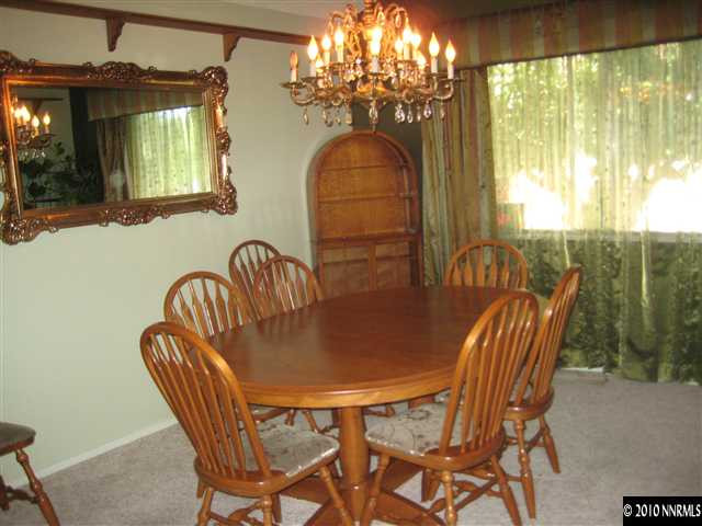 4320 Warren Way Reno, NV 89509 - Photo 3 of 9 a dining room with furniture a chandelier and window
