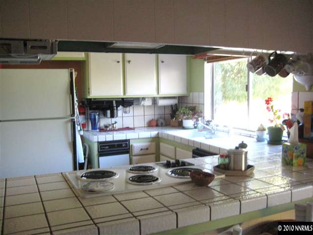 4320 Warren Way Reno, NV 89509 - Photo 5 of 9 a kitchen with stainless steel appliances granite countertop a sink and a stove