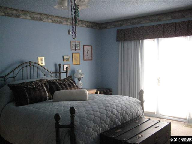 4320 Warren Way Reno, NV 89509 - Photo 6 of 9 a bedroom with a bed and window