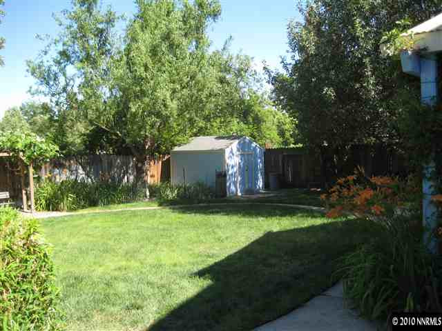 4320 Warren Way Reno, NV 89509 - Photo 8 of 9 a backyard of a house with plants and large trees