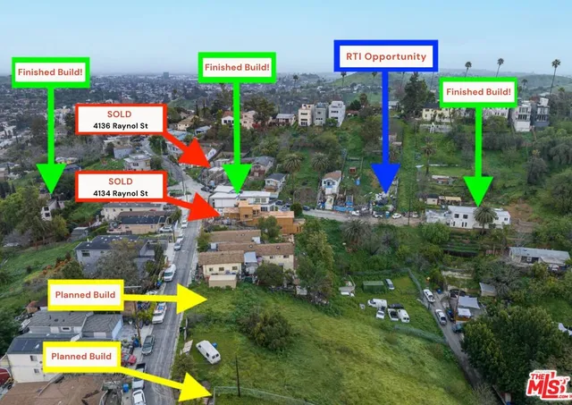 an aerial view of a house with a city