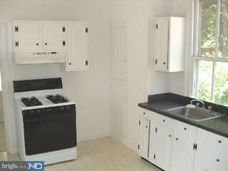 226 Chestnut Street Spring City, PA 19475 - Photo 5 of 6 a kitchen with granite countertop white cabinets and white appliances