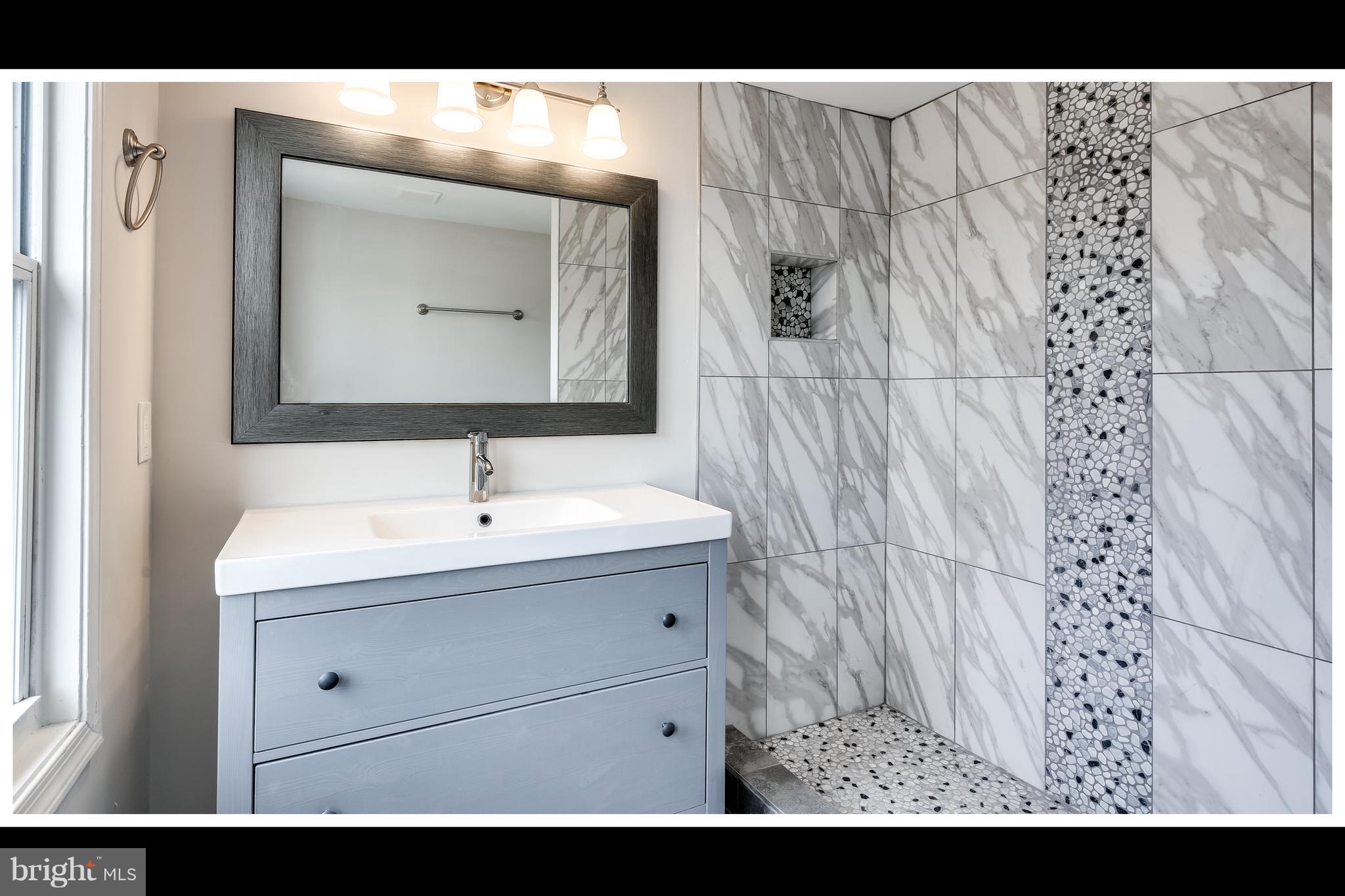 2900 Allendale Road Baltimore, MD 21216 - Photo 28 of 29 a bathroom with a sink and a mirror
