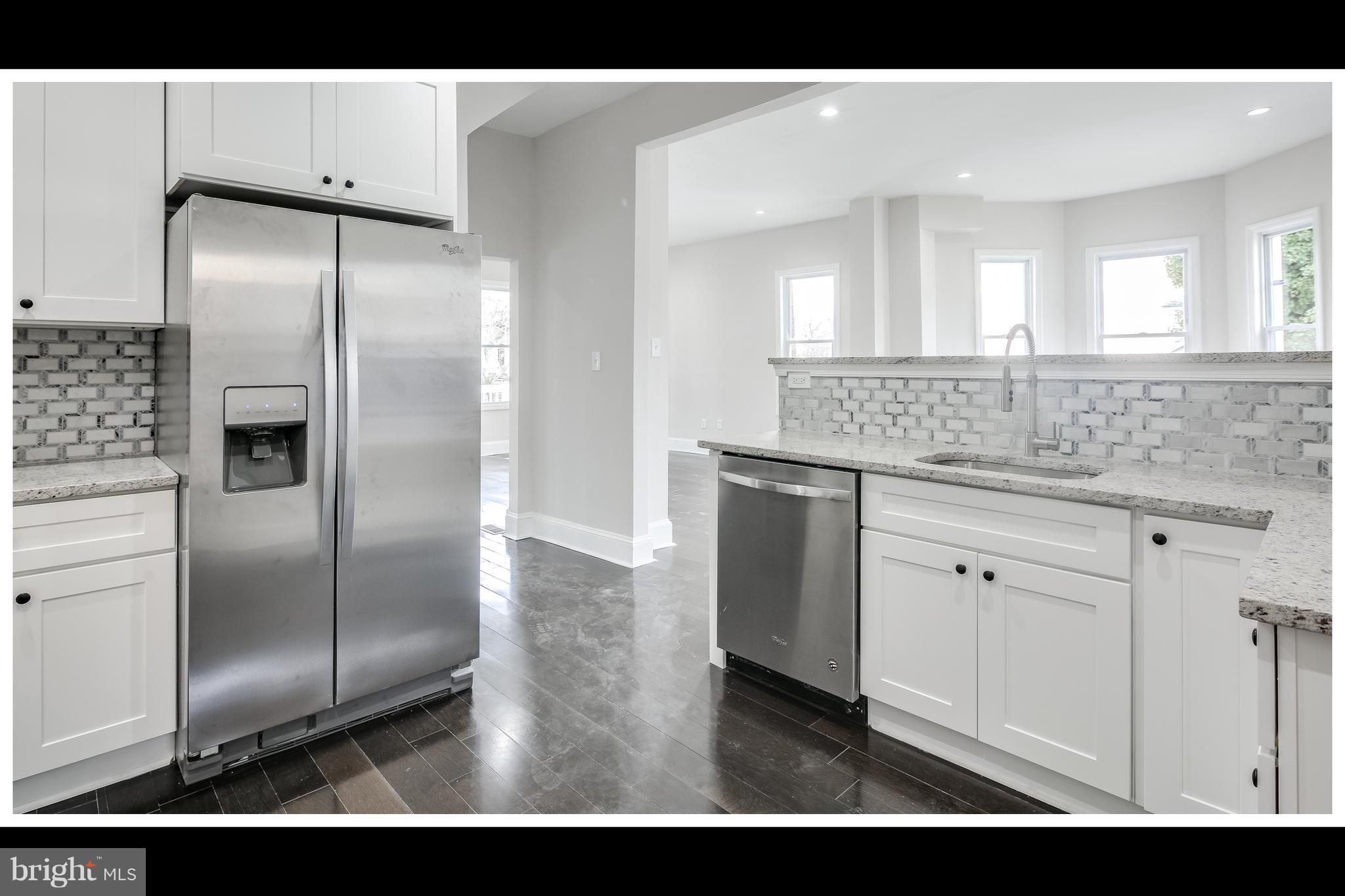 2900 Allendale Road Baltimore, MD 21216 - Photo 7 of 29 a kitchen with kitchen island a counter top space cabinets and stainless steel appliances