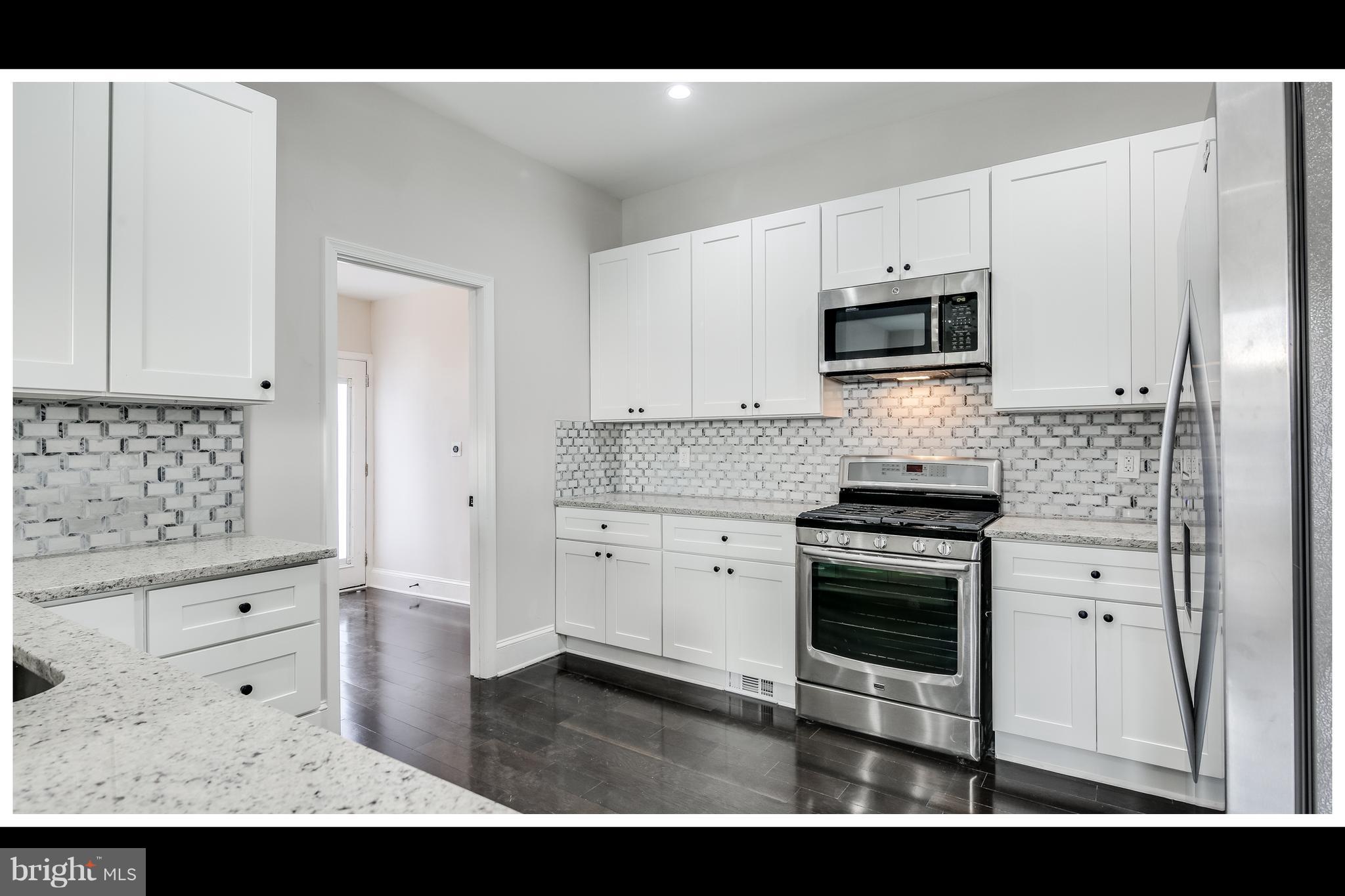 2900 Allendale Road Baltimore, MD 21216 - Photo 8 of 29 a kitchen with granite countertop a sink cabinets and stainless steel appliances