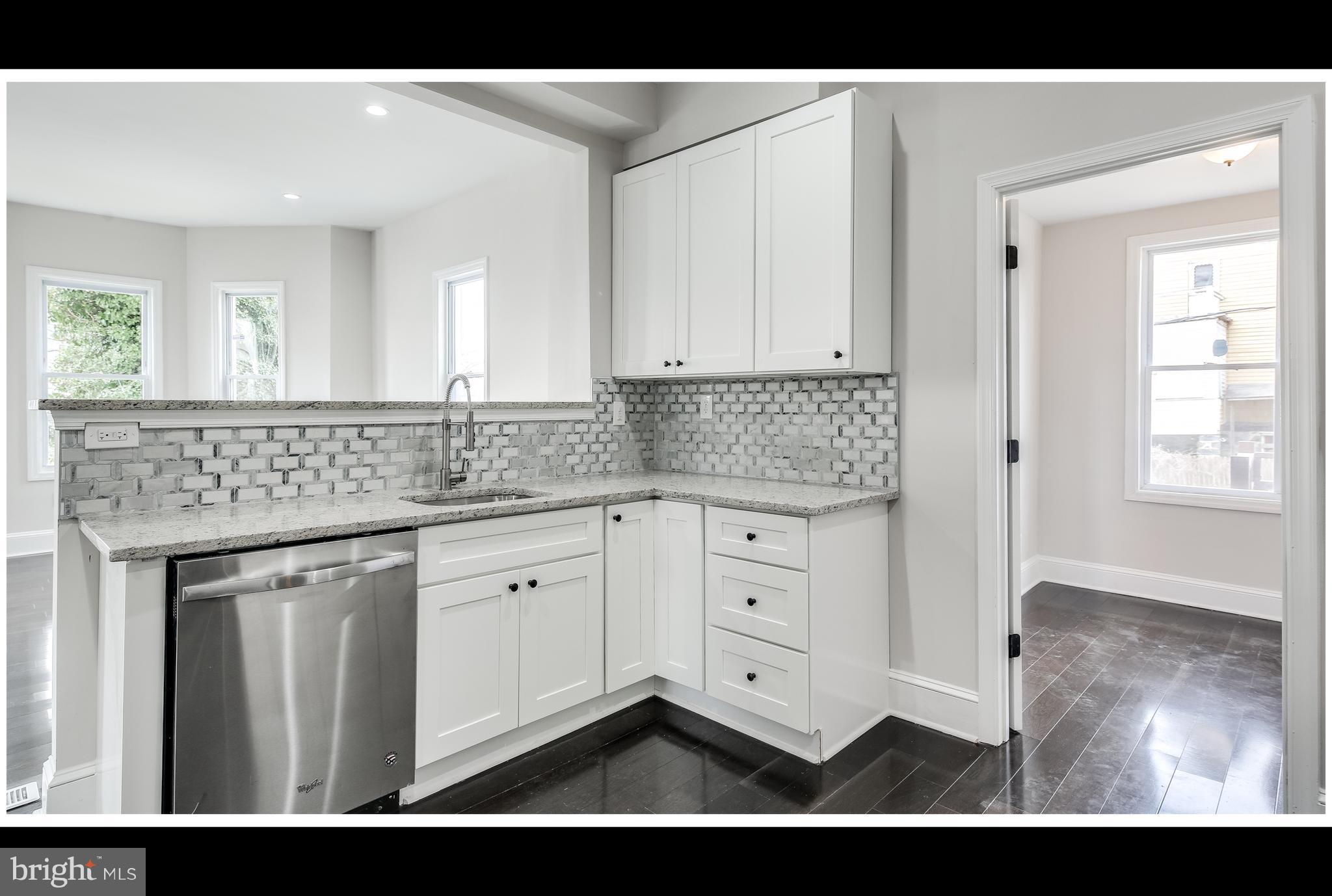 2900 Allendale Road Baltimore, MD 21216 - Photo 9 of 29 a kitchen with granite countertop a sink cabinets and wooden floor