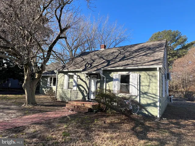 a view of a house with a tree beside of it