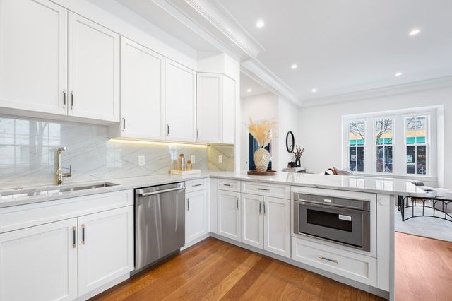 a kitchen with a sink stove and cabinets