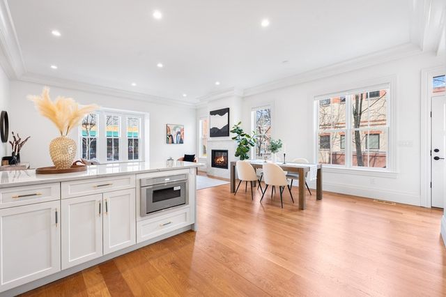 a living room with furniture and a kitchen view