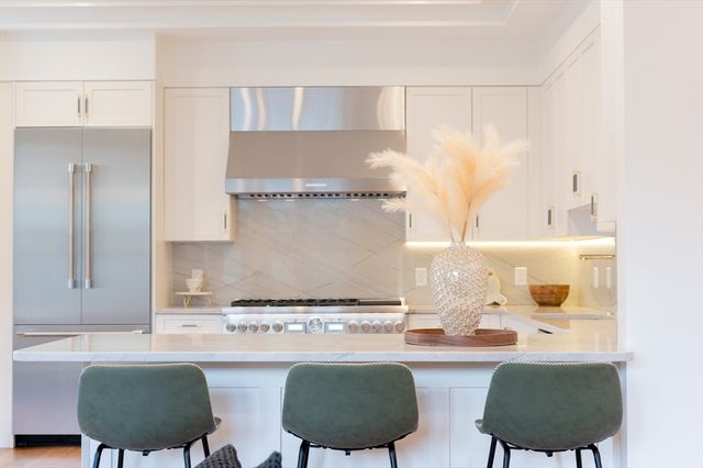 a kitchen with a sink and a stove top oven