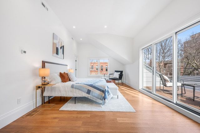 a bedroom with furniture and a large window