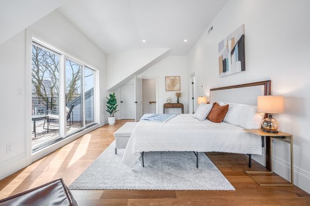 a bed sitting in a bedroom next to a window