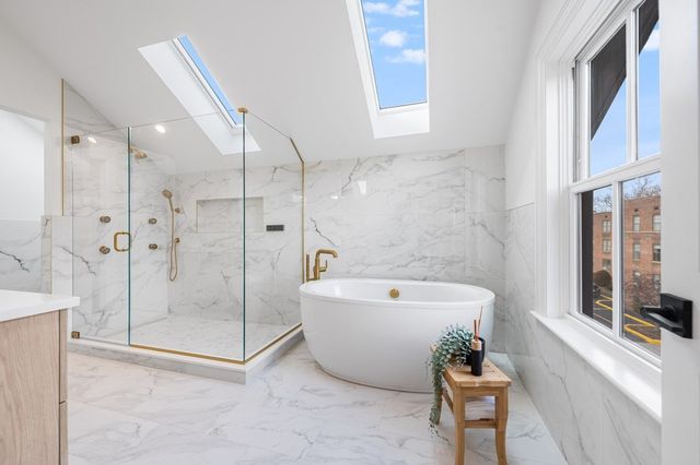 a bathroom with a bathtub and a shower