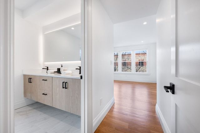 a bathroom with a sink vanity and mirror