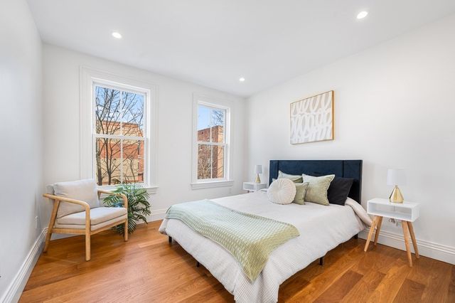 a bedroom with a bed and chair