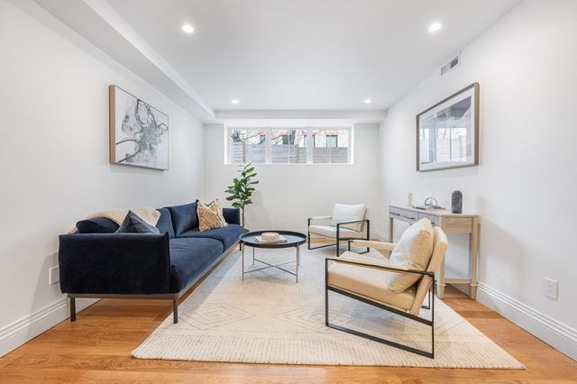 a living room with furniture and a rug
