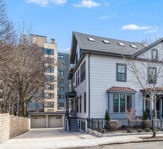 a front view of a residential apartment building with a yard
