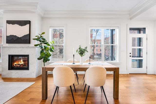 a dining room with furniture and a fireplace