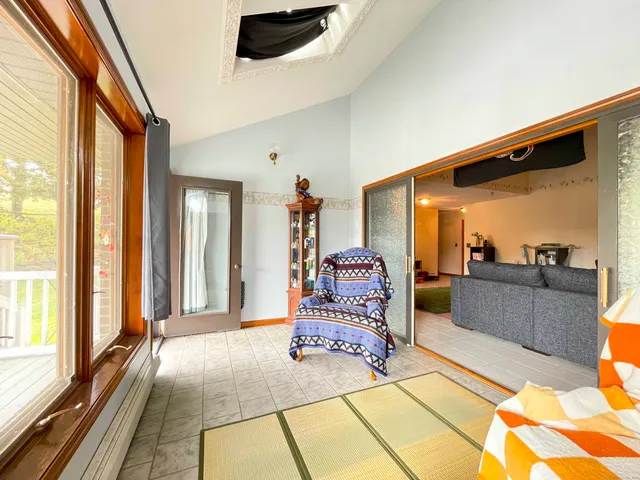 a spacious bedroom with a large bed and a chandelier