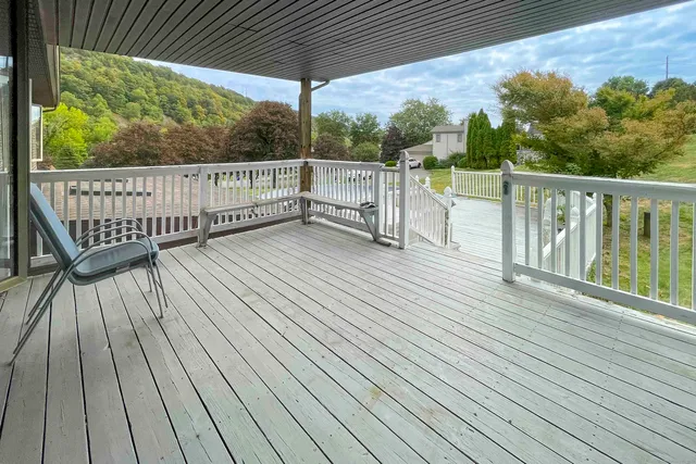 a view of a wooden deck with a yard