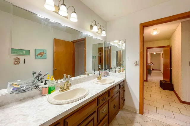 a bathroom with a granite countertop sink and a mirror