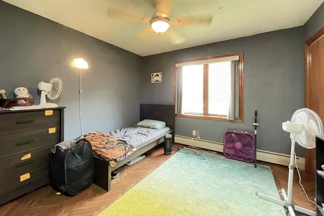 a bedroom with a bed and a window