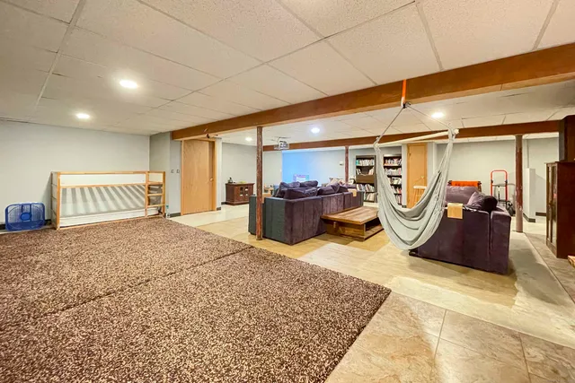 a view of a livingroom with furniture and a gym
