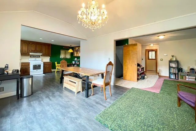 a living room with fireplace furniture and a chandelier