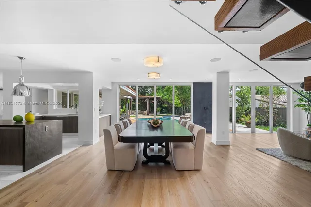a living room with couches and painting on the wall with wooden floor