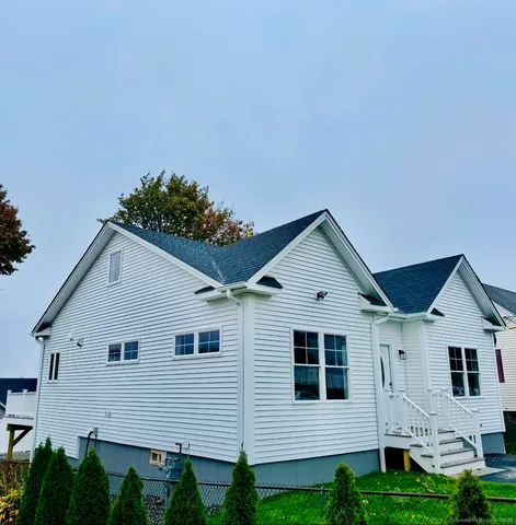 a view of house with yard and a garden