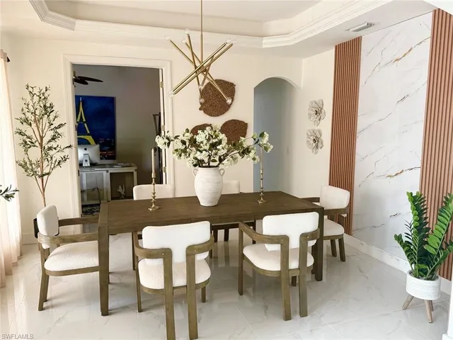 a view of a dining room with furniture and chandelier