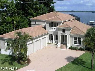 a aerial view of a house with a yard and potted plants