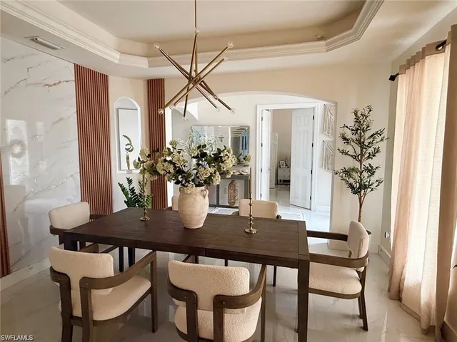a view of a dining room with furniture and window