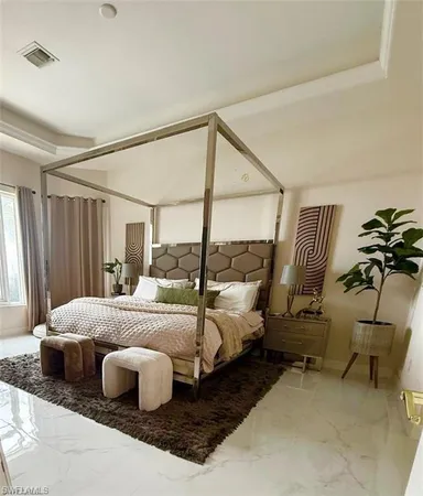 a bedroom with a bed and large mirror