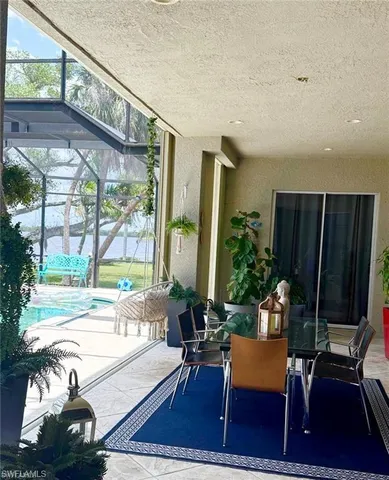 a living room with furniture floor to ceiling window and wooden floor