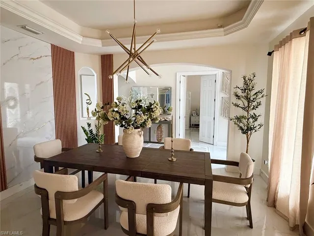 a view of a dining room with furniture and window
