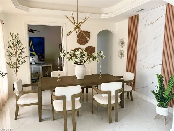 a view of a dining room with furniture and chandelier