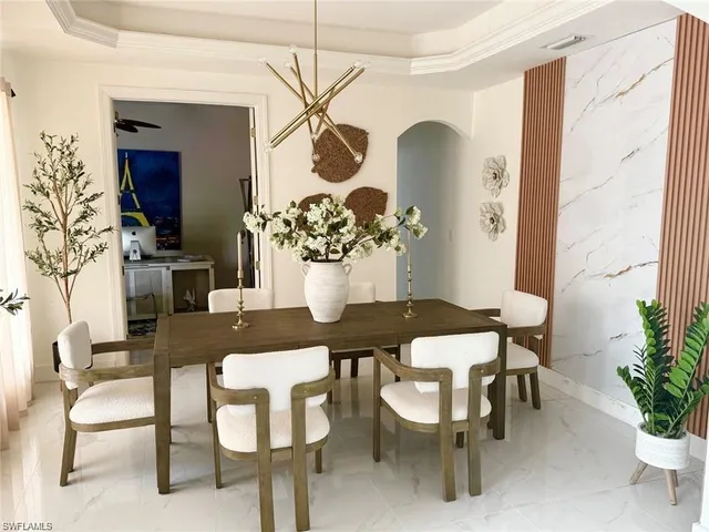 a view of a dining room with furniture and chandelier