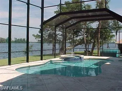 a backyard of water fountain with large trees