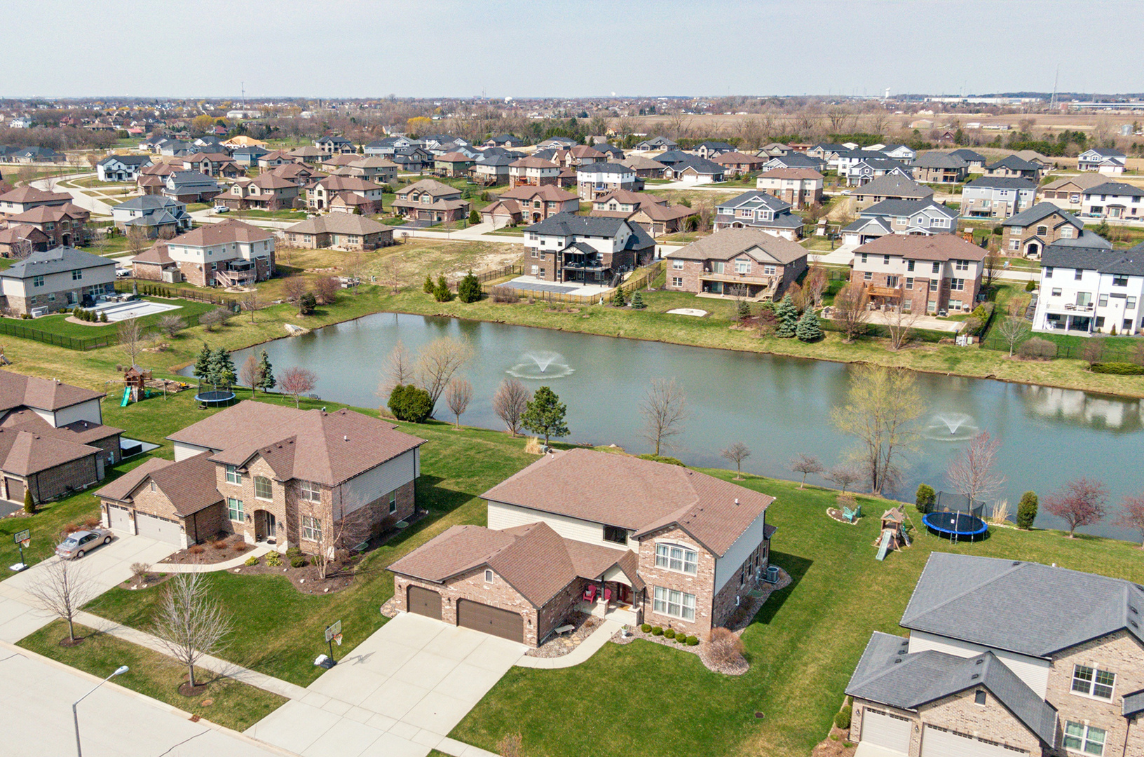 an aerial view of a houses with a lake