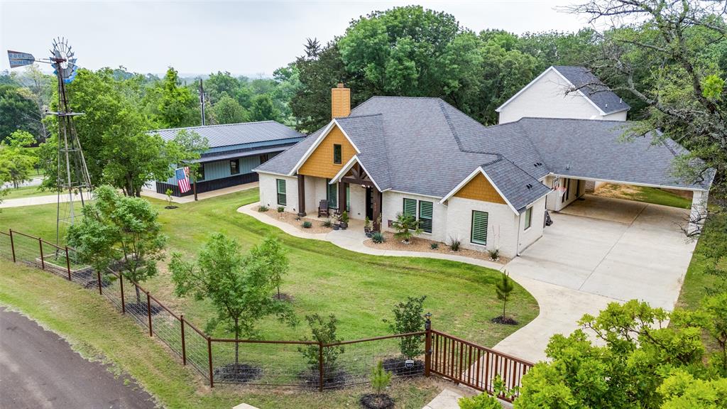 Stunning Residence with 30x60 workshop, 30' windmill, fenced and gated, Multi-generational home options, 1.5 acres, mature trees, outdoor kitchen and more!