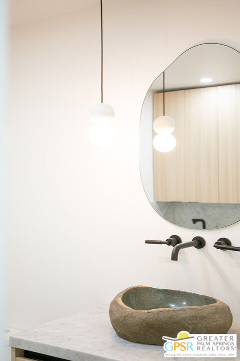 48940 Desert Flower Drive Palm Desert, CA 92260 - Photo 11 of 31 a view of a room with a sink and mirror