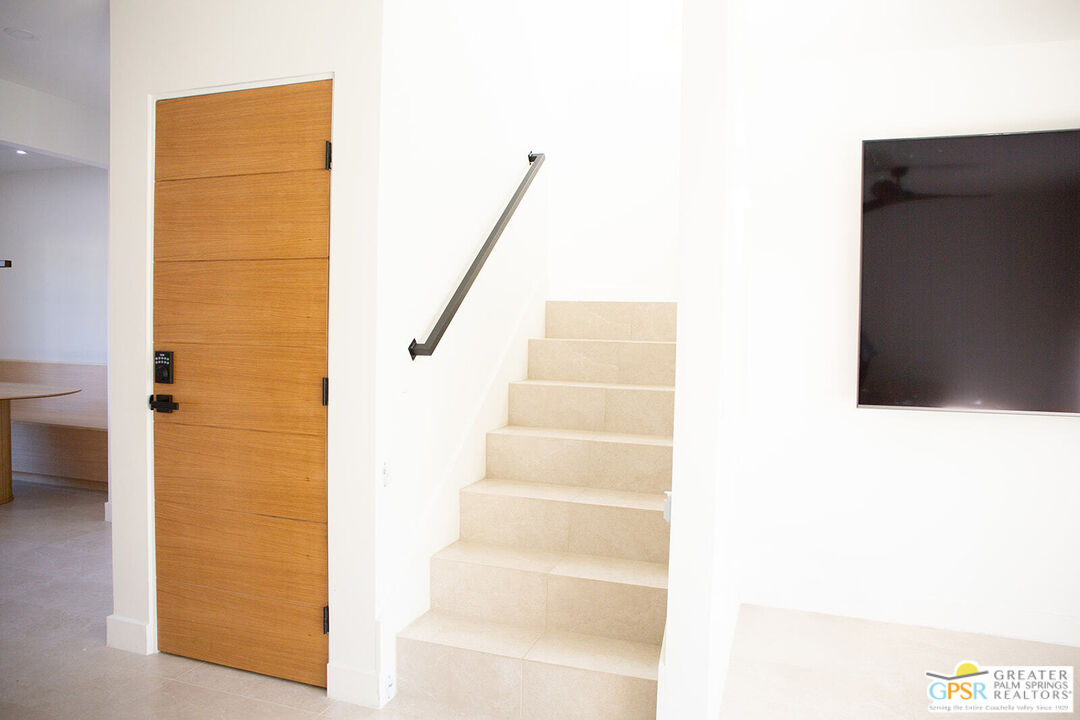 48940 Desert Flower Drive Palm Desert, CA 92260 - Photo 12 of 31 a view of staircase with white walls