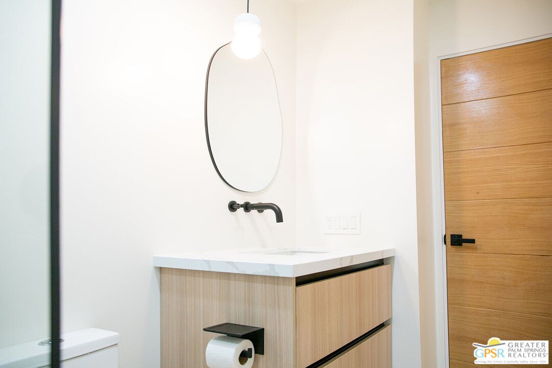 48940 Desert Flower Drive Palm Desert, CA 92260 - Photo 15 of 31 a bathroom with a sink and mirror