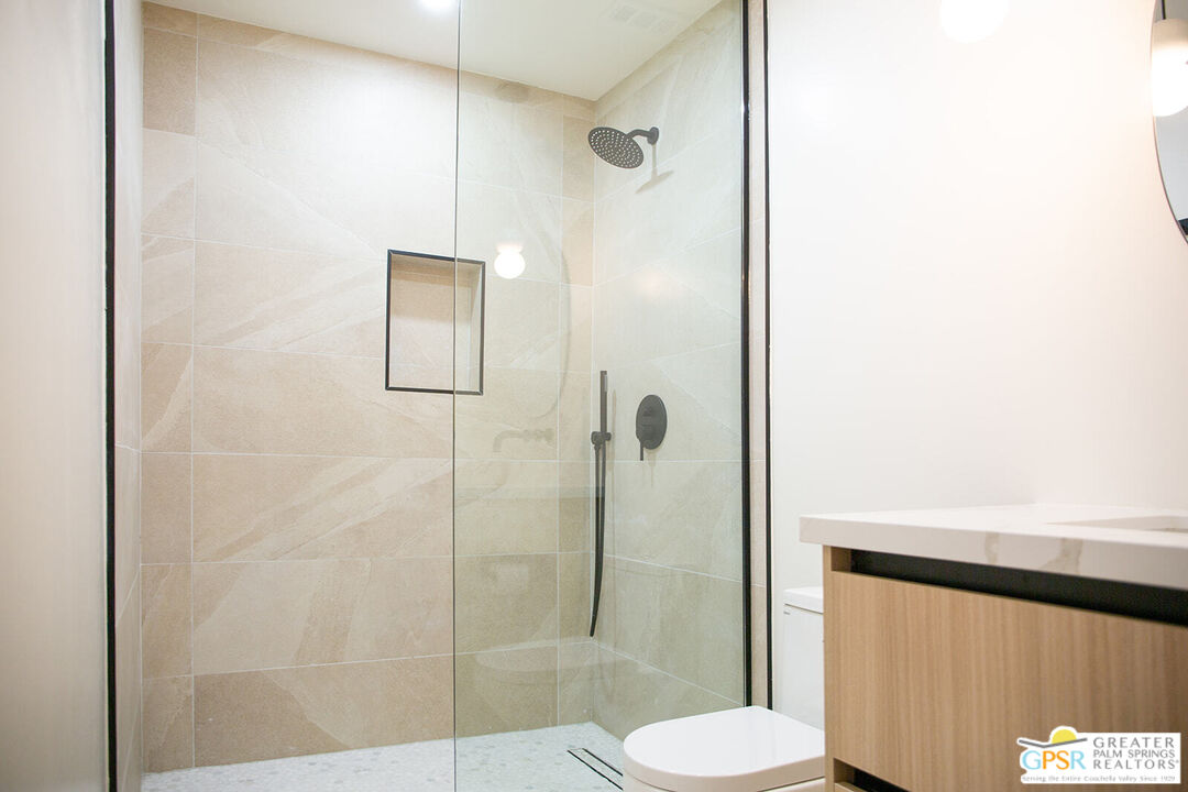 48940 Desert Flower Drive Palm Desert, CA 92260 - Photo 17 of 31 a bathroom with a shower and toilet