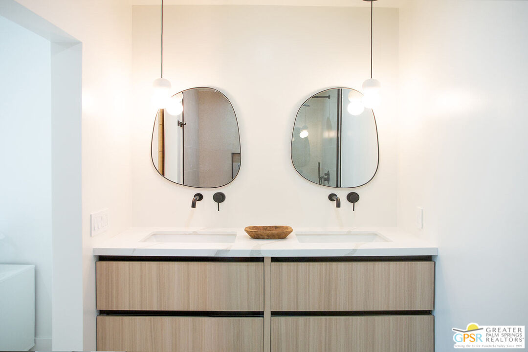 48940 Desert Flower Drive Palm Desert, CA 92260 - Photo 20 of 31 a bathroom with a double vanity sink and mirror
